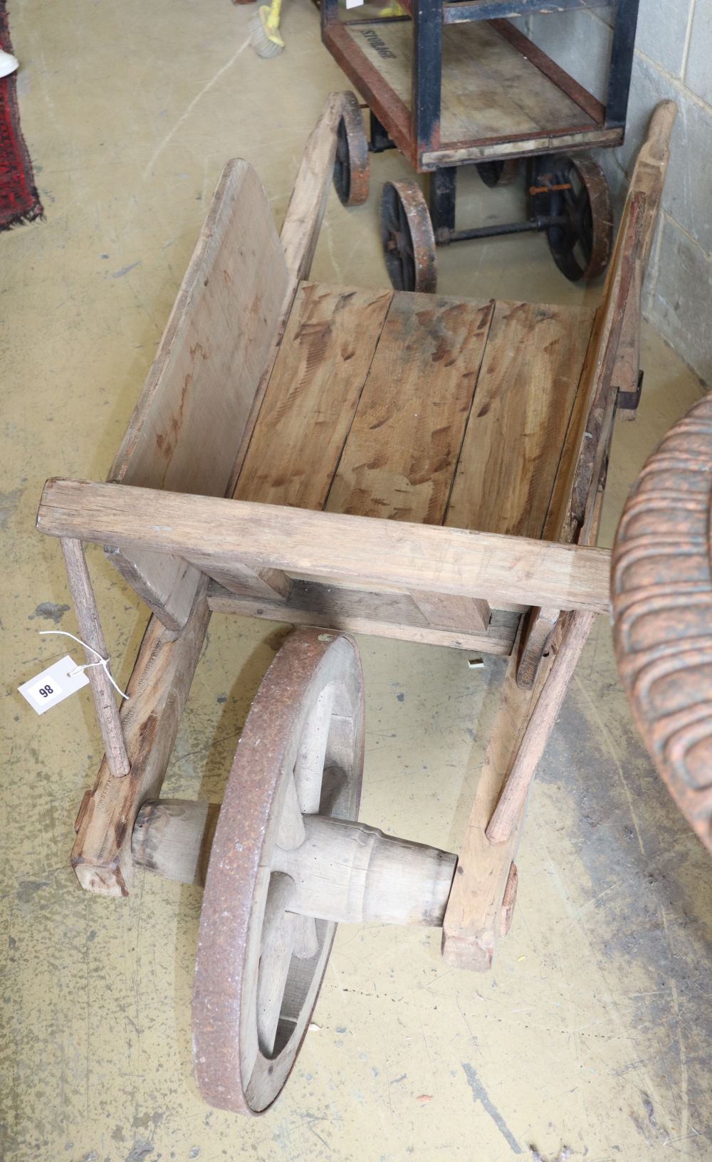 A wooden garden wheelbarrow, L.168cm